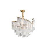 "A tiered chandelier with clear crystal rods and a brass frame, isolated on a white background."