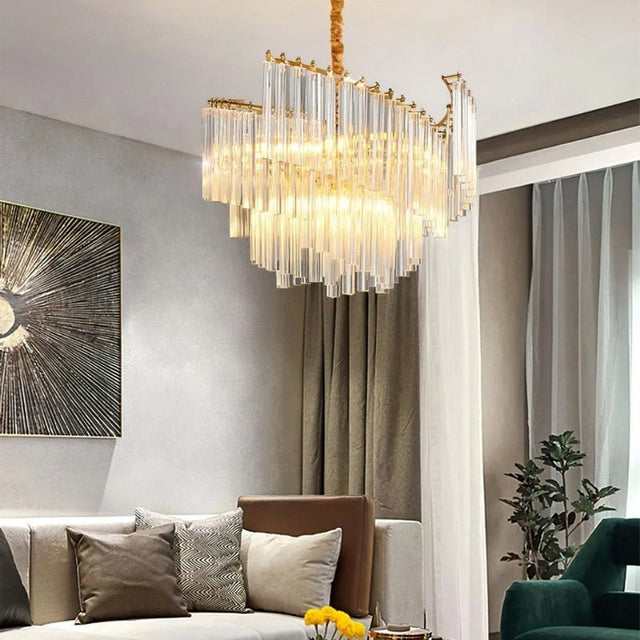 "A modern tiered chandelier with clear crystal rods, illuminating a contemporary living room with soft light."