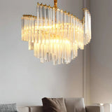 "A multi-tiered chandelier with clear glass rods, illuminated in a living room, creating a warm ambiance."