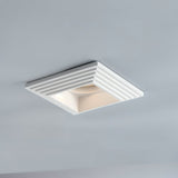 "Recessed square downlight made from gypsum and aluminum with ribbed edges, offering focused, glare-free illumination in modern kitchens, living rooms, and offices."