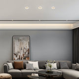 "Living room with multiple Loux Trimless Downlights providing seamless, minimalist illumination, crafted from gypsum and aluminum, enhancing the modern decor."