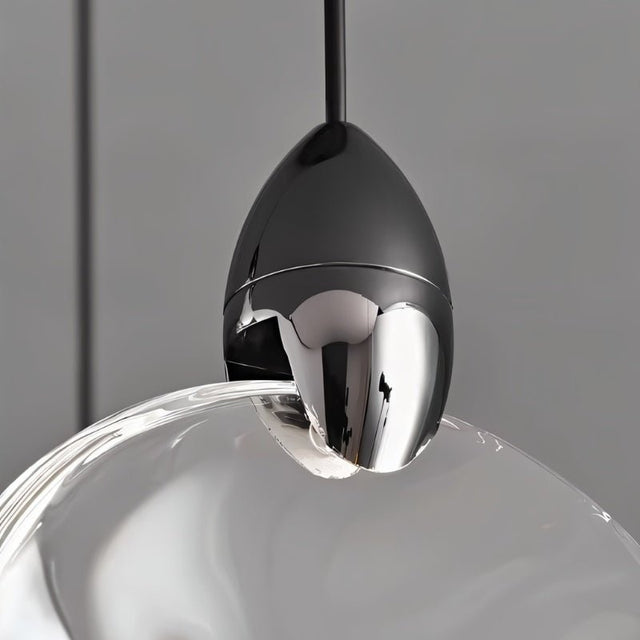 "Close-up of a crystal pendant light with black hardware, showcasing the elegant design and detailing."