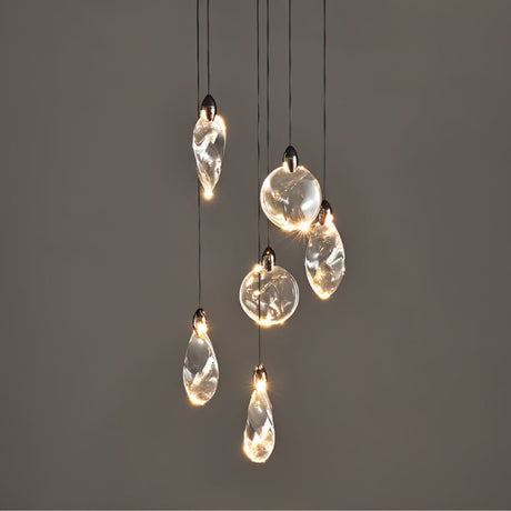 "A cluster of uniquely shaped crystal pendant lights hang against a dark grey background, showcasing their elegant design and warm, ambient glow."