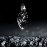 "Close-up of a uniquely shaped crystal droplet pendant light, showcasing its elegant design and the way it diffuses light."