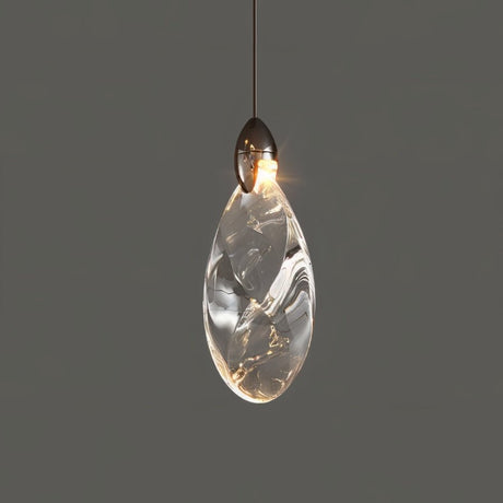 "A single, teardrop-shaped crystal pendant light with a dark metallic top, casting a warm glow against a grey background."