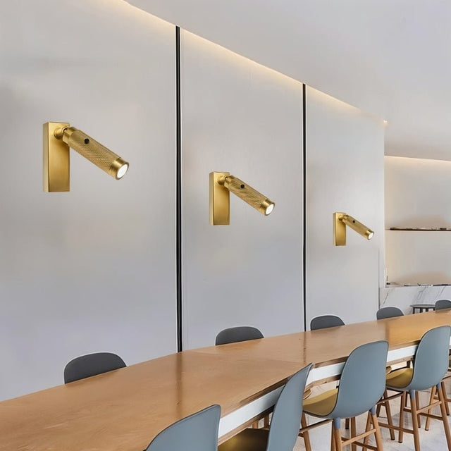"Multiple modern bedside reading lamps with a textured polished metal finish, wall-mounted with adjustable light direction, enhancing a contemporary space."