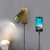 "Wall-mounted bedside reading lamp with adjustable light, polished metal finish, USB connection, and a phone charging via the integrated USB port."