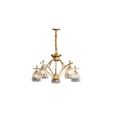 "Gold chandelier with five glass shades on an arched frame."