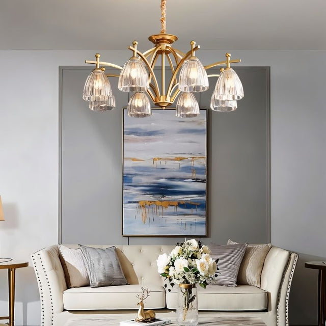 "Gold chandelier with six glass shades hanging over a living room sofa."