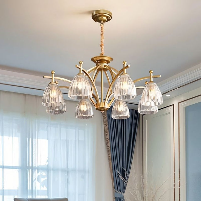 "Close-up of a gold chandelier with eight glass shades hanging over a dining room table."