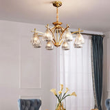 "Gold chandelier with eight glass shades hanging over a dining room table."