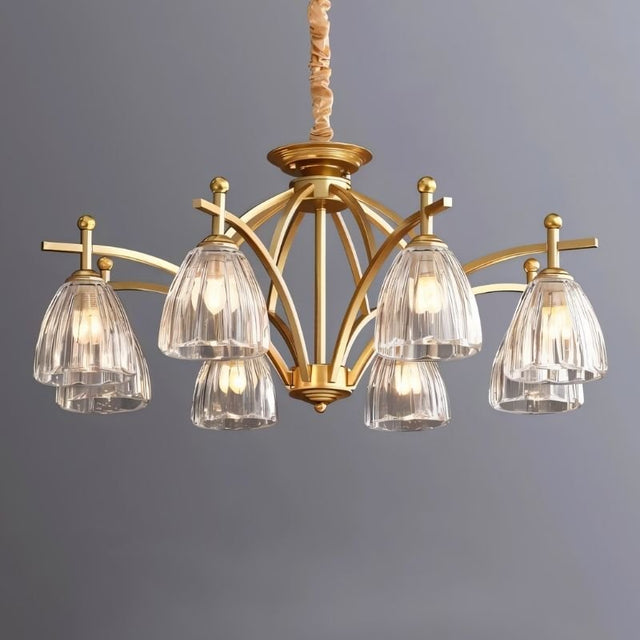 "Gold chandelier with eight glass shades against a gray background."