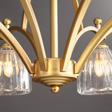 "Close-up of the base of a gold chandelier with textured glass shades."