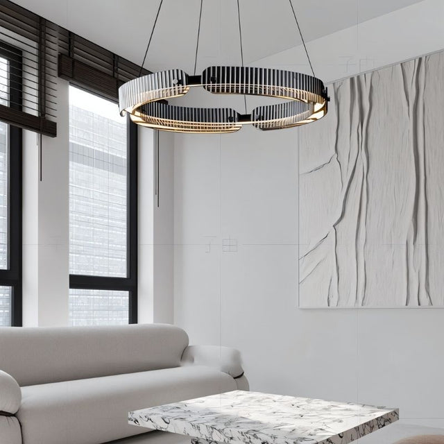 "A modern, circular chandelier with a segmented ring design, made of iron and glass, suspended by thin cables in a contemporary living room."