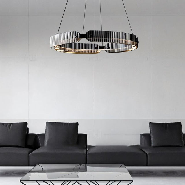 "A modern, circular chandelier with a segmented ring design, made of iron and glass, suspended by thin cables in a minimalist living space."