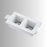 "Trimless recessed downlight fixture with dual square openings, crafted from gypsum and aluminum, offering a sleek and minimalist design for focused, efficient lighting."