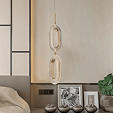 Luxin Sculptural Pendant Light with stacked oval LED rings, enhancing a minimalist bedroom with neutral tones and modern decor.