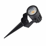 "Angled view of an outdoor spotlight with spike mount, aluminum body, and adjustable head."