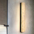 "A New Chinese wall lamp featuring a rectangular panel of translucent marble, providing a soft, ambient glow and showcasing the stone's natural veining."