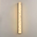 "Contemporary wall lamp featuring a slender panel of translucent marble with subtle copper accents, providing a soft, ambient glow."