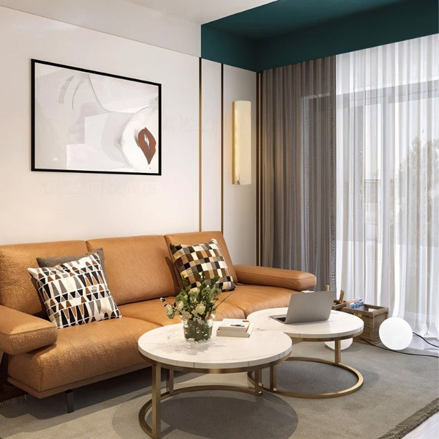 "A New wall lamp featuring a translucent marble panel and copper accents, providing a soft glow in a modern living room setting."