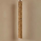 Marus Pendant Light - Open Box | Sleek Travertine Fixture illuminated in warm lighting, highlighting its earthy texture and tone.