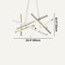 Modern geometric chandelier with mixed metal finishes in gray, white, and brass tones, suspended against a light background.