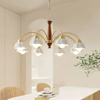 "An eight-light chandelier with curved ceramic shades and a wooden center, illuminating a modern dining room with a warm, ambient light."