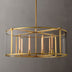 Round brass chandelier with glass cylinder shade and exposed candle-style lights against neutral background.