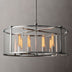 Round pendant chandelier with brushed metal frame and glass cylinder shade featuring six glowing Edison-style bulbs.
