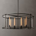Round pendant chandelier with black metal frame and clear glass shade featuring eight gold tube lights against gray background.