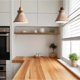 Pair of Menra Pendant Lights above a wooden kitchen counter, blending stone and wood for a minimalist modern kitchen look.