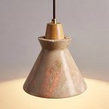 Detailed view of Menra Pendant Light showing polished travertine surface and wood accent, emitting soft ambient light.