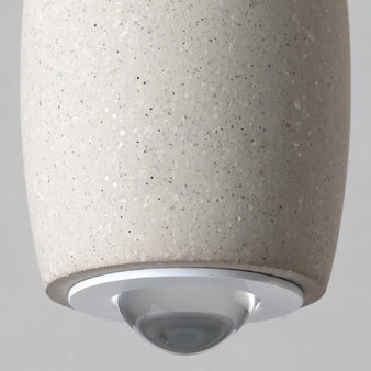 "Close-up view of the Meret Pendant Light showcasing its durable cement material with a smooth, speckled finish and aluminum fixture"