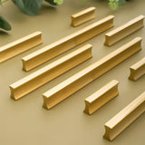 "Sleek geometric brass pull bars with a brushed finish for modern minimalist cabinets."
