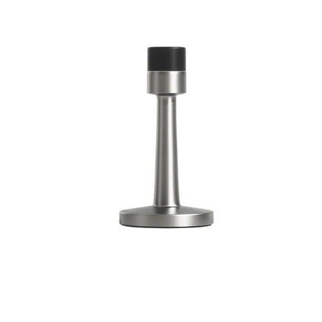 "Sleek, cylindrical door stop in brushed nickel zinc-alloy with a sturdy base and extended arm to prevent doors from hitting walls in modern interiors."