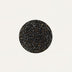 Black speckled terrazzo circle on white background.