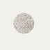 Circular terrazzo disc with black and white speckled pattern on neutral background.