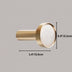 Brass knob with white marble inlay, measuring 1.4 inches wide by 0.9 inches tall, shown against gray background.