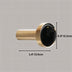 Black marble oval knob with brushed gold cylindrical stem on neutral background.