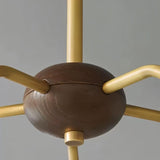 "Close-up detail of a modern chandelier with copper and glass elements, showcasing its minimalist design."