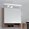 "Wall-mounted bathroom cabinet with a mirrored door, a light fixture above, and two black bowls on an open shelf below."
