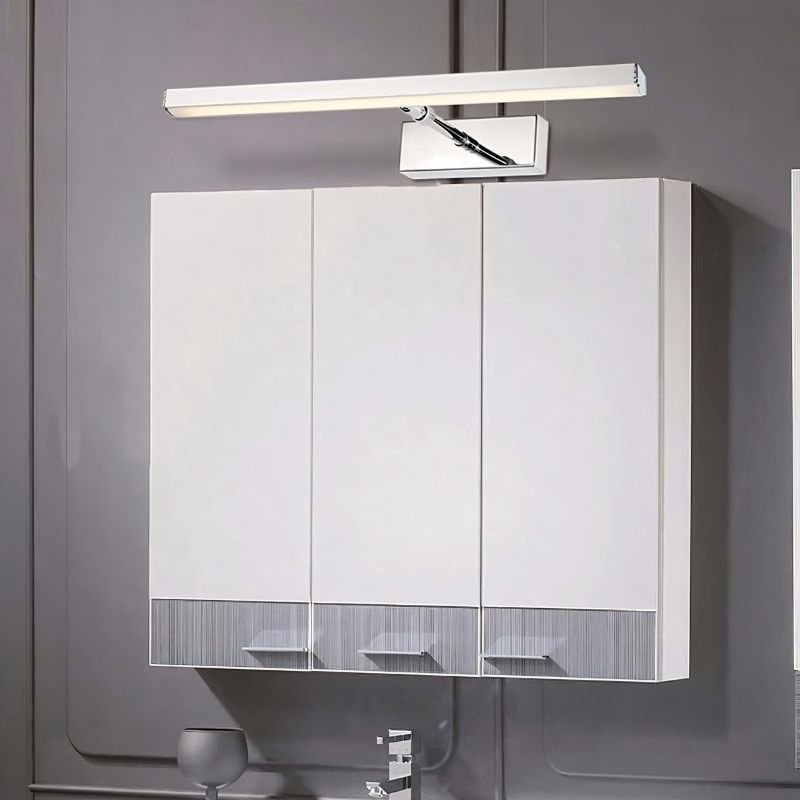"A bathroom showcasing a white cabinet and mirror, complemented by the elegant Mirvia Wall Lamp for optimal grooming illumination."