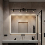 "Modern black bathroom vanity lighting with four adjustable heads mounted on a circular base above a large rectangular mirror."