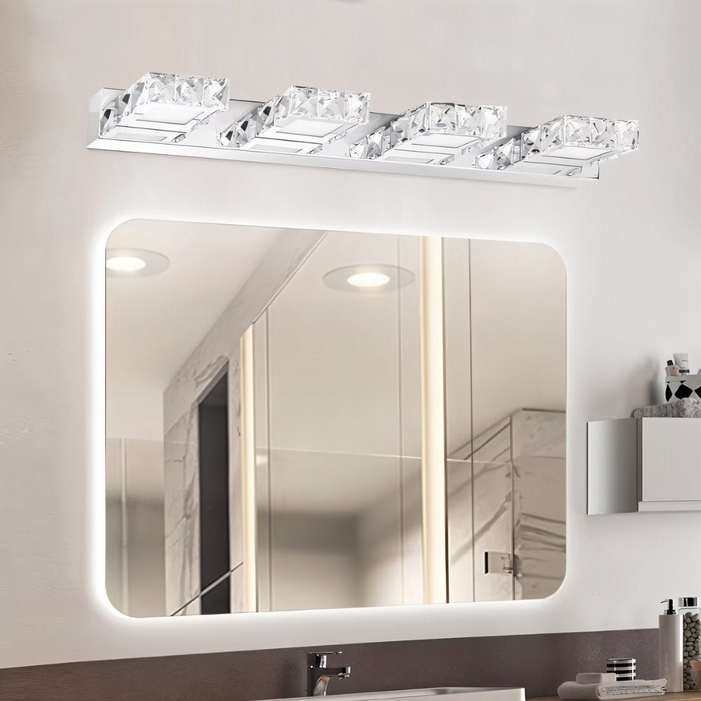 "A modern crystal LED bathroom vanity light fixture mounted above a rectangular mirror with rounded corners in a well-lit bathroom."