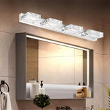 "Modern crystal vanity lighting fixture mounted above a large mirror in a contemporary bathroom with gray cabinetry."