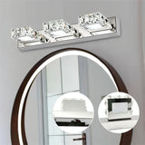 "A modern crystal wall light fixture mounted above an oval mirror in a bathroom, with close-up insets showcasing the crystal and metal detailing."