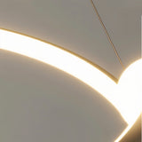 "Close-up detail of a modern curved light fixture, showing the illuminated element." 