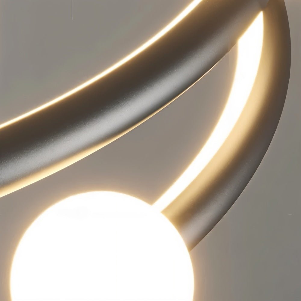 "Close-up detail of a modern curved light fixture, showing the illuminated element and a spherical bulb." 