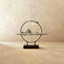 Meditation Buddha statue with golden neon halo ring, seated on wooden shelf with decorative plants and lotus flower, dark stu